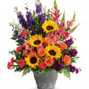 A colorful reminder that brighter days are ahead, this uplifting arrangement of