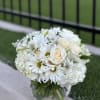 Beautiful floral arrangement a clear vase. Dusty Miller greens, white Dahlia, white