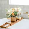 Reminiscent of a desert sunrise, this modern mix of peach blooms, white