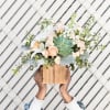 Reminiscent of a desert sunrise, this modern mix of peach blooms, white