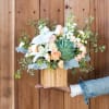 Reminiscent of a desert sunrise, this modern mix of peach blooms, white