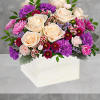 Springtime beauty at its best! Creamy roses and deep purple blooms in