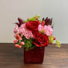 Beautiful arrangement of reds, pinks, and berries.  Includes red roses, pink