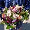 Beautiful rich mix of peach, blush, purple and burgundy roses ad other