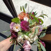 Beautiful mix of blush, peach, purple and burgundy roses, scabiosa, butterfly and