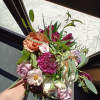 Beautiful mix of blush, peach, purple and burgundy roses, scabiosa, butterfly and