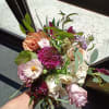 Beautiful mix of blush, peach, purple and burgundy roses, scabiosa, butterfly and