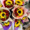 8 mix roses with 1 sunflower in the middle 