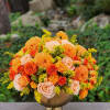 Celebrate autumn with this vibrant arrangement of orange dahlias, roses, and yellow