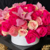 A mix of hot and light pink roses, and cymbidium orchids