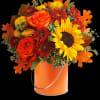 Greet the new season with this heartwarming sunflower and rose bouquet, presented