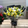 A stunning arrangement of yellow tulips with white flowers.