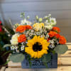 Enjoy this beautiful arrangement of yellow sunflowers and orange roses, resembling a