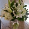 An elegant arrangement of white hydraengeas and white Lillies designed in a