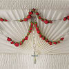 This stunning 50-bead rosary graced with red spray roses and placed inside