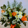This is one-sided arrangement with white chrysanthemums, orange lilies, and other flowers.
