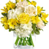 This sparkling array of sunny favorites in a glass cube vase will