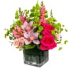 Escape to paradise with this lush and vibrant flower arrangement.  This