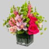 Escape to paradise with this lush and vibrant flower arrangement.  This
