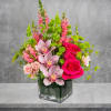 Escape to paradise with this lush and vibrant flower arrangement.  This
