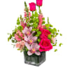 Escape to paradise with this lush and vibrant flower arrangement.  This