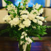 This elegant mixed bouquet is composed of Roses, Carnations, Snapdragons, Stock, and