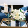 Like gazing into a clear blue sky, this serene arrangement soothes the