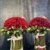 This is hard worked arrangement that is with vase and red roses