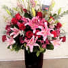 This design includes two dozen Roses, Lilies, Snapdragons, Alstroemeria, various foliage, and