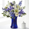 This handcrafted bouquet of white and blue roses, stock, iris, roses, delphinium