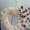Heart with white roses, white hydrangeas, white lilies, and white orchids with