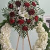 Open wreath with white hydrangeas, red roses, and white lilies.