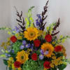 A Basket filled with Sunflowers,Iris,Red Roses, Bells of Ireland,Yelliow Alstromeria and assorted