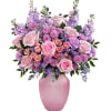What a delight! Overflowing with pink roses and lavender blooms, this decadent