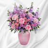What a delight! Overflowing with pink roses and lavender blooms, this decadent