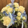 Envision a charming floral arrangement celebrating a baby boy. With beautiful blue