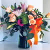 Seasonal blooms in a custom vase.