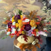 Celebrate the season with our one-of-a-kind Limited Edition Fall Pumpkin Floral Arrangement!