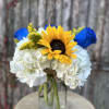 Sunflowers, blue roses, hydrangeas. 