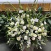 Very large container of all white flowers arranged to be viewed from