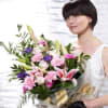 This ultra-feminine presentation bouquet in sumptuous shades of pink and purple includes