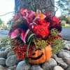 Celebrate the spirit of Halloween with this charming arrangement featuring soft pink