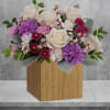 Swirling with flowers this sweet floral arrangement makes a marvelous gift filled