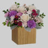 Swirling with flowers this sweet floral arrangement makes a marvelous gift filled