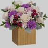 Swirling with flowers this sweet floral arrangement makes a marvelous gift filled