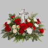 The crystal cross is nestled elegantly among red and white blooms, this