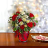 All dressed up in classic Christmas colors, this holiday floral arrangement is