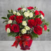 All dressed up in classic Christmas colors, this holiday floral arrangement is