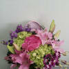 Box arrangement with roses, stocks, hydrangeas, lilies, and orchids. 