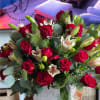 Large combination of red roses, white lilies and seasonal greenery.


